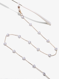Détail de la chaîne à lunettes dorée avec perles cœur blanches et boucles antidérapantes