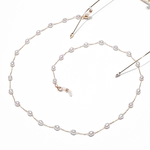 Golden eyewear chain with white pearls and silicone loops on a clean white background