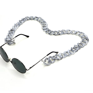 Detail of chunky marble texture acrylic eyeglass chain with black sunglasses