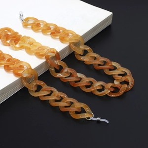 Minimalist amber acrylic eyewear chain with transparent silicone loops and metal hardware