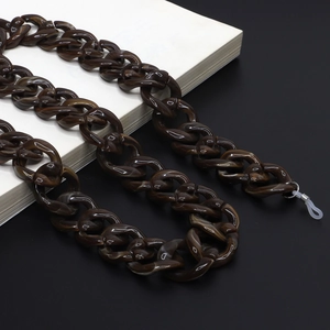 Detail of chunky acrylic eyewear chain with brown tortoiseshell texture and silicone ends
