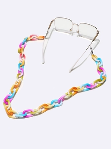 Macro shot of colorful marbled acrylic links connected to a gold metal eyeglass chain