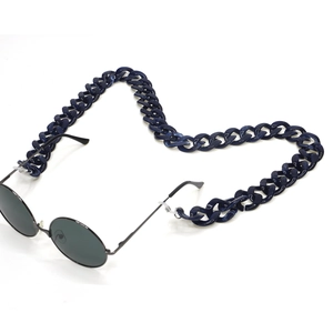 Detailed view of dark blue marbled acrylic chunky chain connected to retro sunglasses