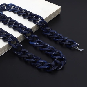 Macro detail of dark blue acrylic eyeglass chain with marble texture and silicone loops
