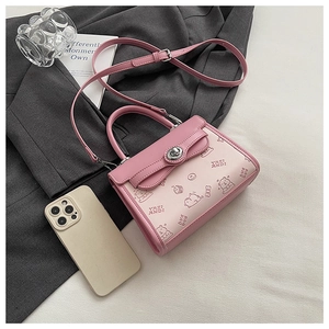Detail of pink contrast leather crossbody bag with cartoon bear print and silver twist lock