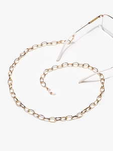 Detail of gold metal glasses chain with silicone loops in a creative spiral arrangement
