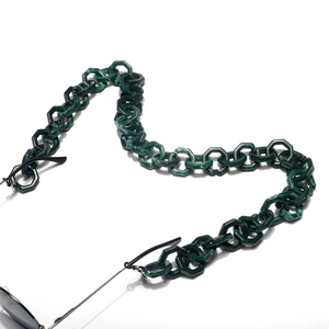 Detail of dark green acrylic eyewear chain with hexagon links and marble texture