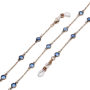 Detail of gold glasses chain with faceted blue glass beads and silicone loops