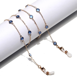 Detail of gold glasses chain featuring blue glass beads and secure anti-slip silicone ends
