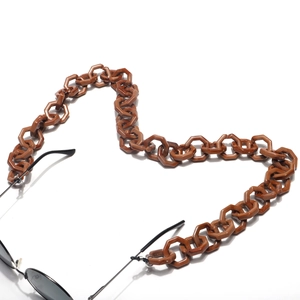 Brown acrylic eyewear chain with thick hexagonal links in a heart shape on white background