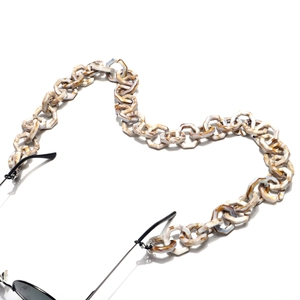 Detail of tortoiseshell acrylic chain for glasses with anti-slip rubber loops in heart shape