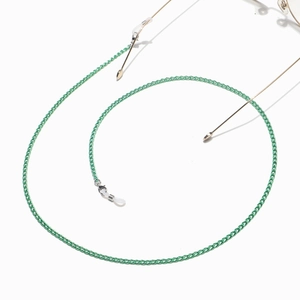 Detailed close-up of green metal glasses chain with non-slip silicone loops and lobster clasp