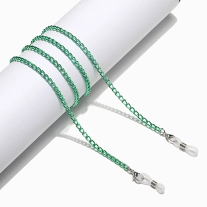 Detail of green metal glasses chain with lobster clasp and silicone loop on a white stand