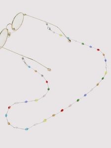 Macro detail of colorful crystal beads on a silver stainless steel eyeglass chain