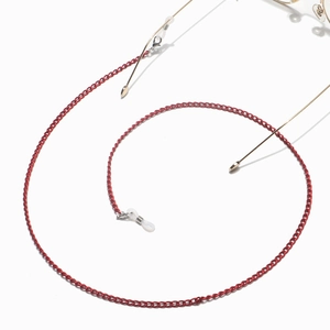 Red metal eyeglasses chain with silicone loops for frames on a white background