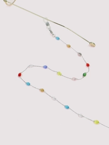 Detail of colorful faceted crystal beads on a stainless steel eyeglass chain link