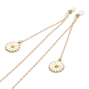 Golden metal eyewear chain featuring two white daisy pendants and silicone loops