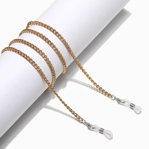 Detail of golden metal glasses chain with white silicone anti-slip ends and lobster clasp