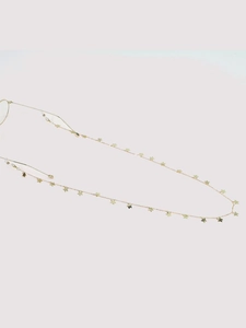 Close-up of golden metal eyeglass chain with delicate miniature butterfly pendants