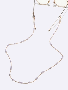 Détail de la chaîne de lunettes faite main avec perles blanches et maillons dorés