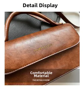 Detailed close-up of brown lychee-textured leather bag with golden fashion inscription