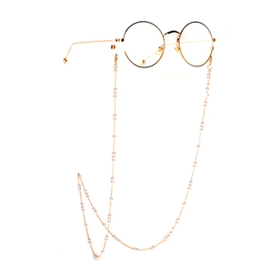 Chaîne de lunettes dorée élégante avec perles blanches sur monture ronde