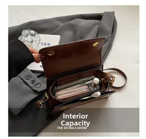 Internal view of brown crossbody bag showing spacious capacity and inner pocket