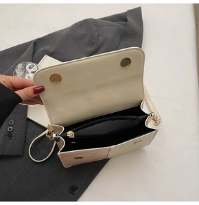 Detailed interior of the two-tone crossbody bag showing the multi-layer storage compartments