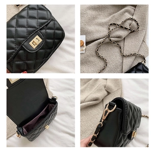 Detail of black quilted shoulder bag featuring gold metal lock and chain strap