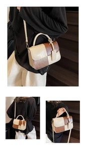 Detail of color-block handbag showing cream and tan PU leather texture with metal buckle