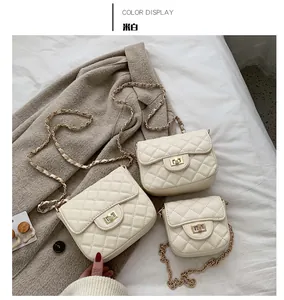 Three-piece set of off-white quilted crossbody bags with gold chain straps and twist locks