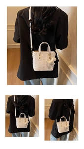 Detailed view of white bucket bag with star embossing and cute astronaut charm