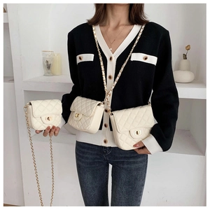 Close-up of three beige quilted chain bags in varying sizes worn by a model