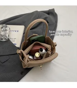 Interior view of lychee leather bucket bag showing zipper compartment and spacious storage