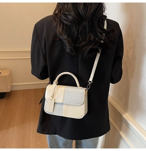 Model view showing the back profile and scale of the color-block crossbody handbag
