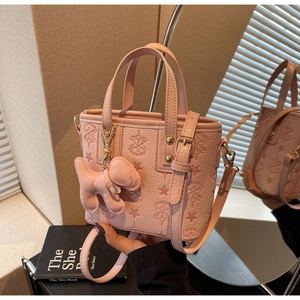 Pink lychee texture bucket bag with star embossing and cute dog charm detail