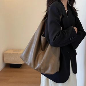 Retro brown large-capacity faux leather tote bag for women shown on a shoulder model