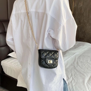 Fashionable black quilted chain crossbody bag with gold hardware for women, model view