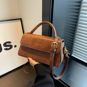 Brown vintage faux leather crossbody bag with top handle and gold buckle detail