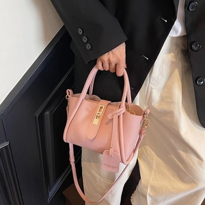 Pink lychee texture leather handbag with gold metal lock and shoulder strap