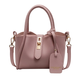 Pink lychee grain leather tote bag with gold swivel lock and adjustable shoulder strap