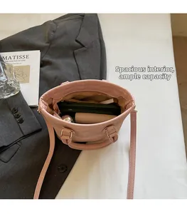 Top view showing the large capacity of the pink leather bucket bag with a long strap