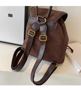 Detail view of smooth long adjustable shoulder straps on vintage brown suede backpack