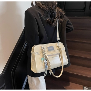 Beige PU leather tote bag details showing front zipper pocket and cute cartoon charms