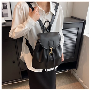Detail of matte PU leather backpack featuring drawstring closure and gold metal buckle hook