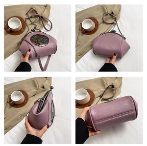 Detail view of purple shell bag with vintage relief pattern and metal chain strap