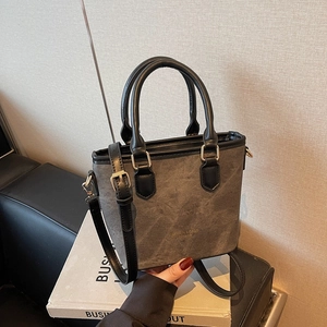 Retro grey textured bucket bag with black handles and gold hardware for daily commuting