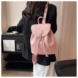 Detailed back view of a pink PU leather backpack with gold metal buckle on a model