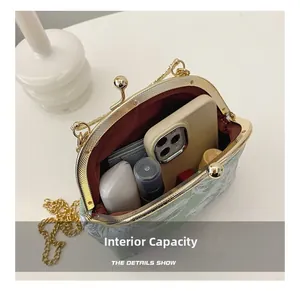 Detail showing the internal capacity of the green jacquard bag with daily essentials