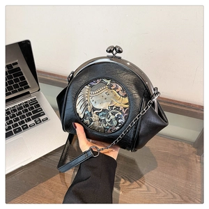 Detail of a vintage black shell bag featuring an intricate round elephant relief motif